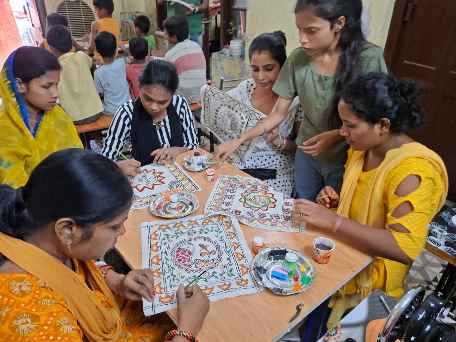 Woman learning to use a sewing machine in an empowerment program