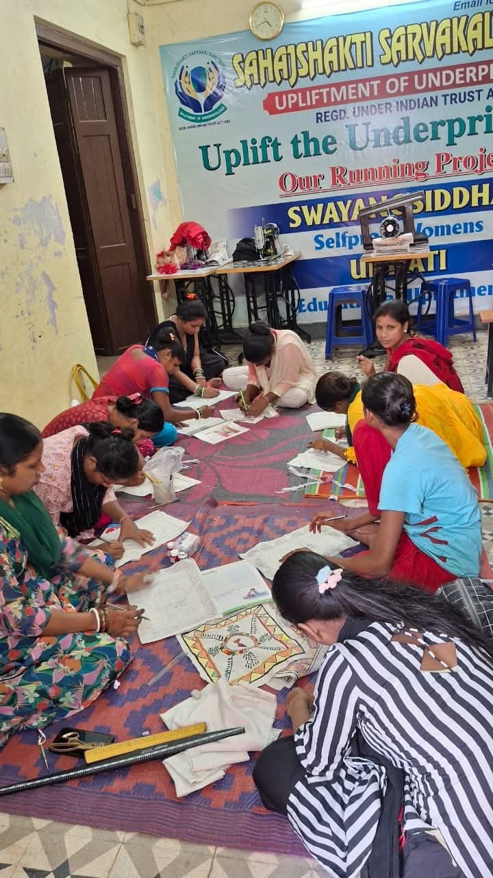 Group of women proudly displaying their stitched products